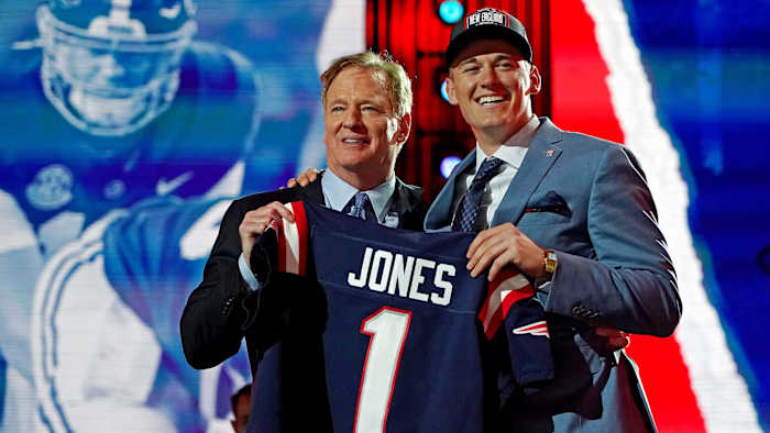Mac Jones (Alabama) with NFL commissioner Roger Goodell after being selected by the New England Patriots as the number 15 overall pick in the first round of the 2021 NFL Draft at First Energy Stadium.